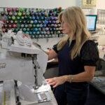 owner Lori Nair works on a custom embroidery